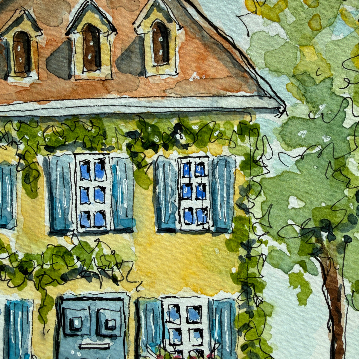 Close-up of the yellow ivy house watercolor showing the terracotta roof, dormer windows and blue shutters