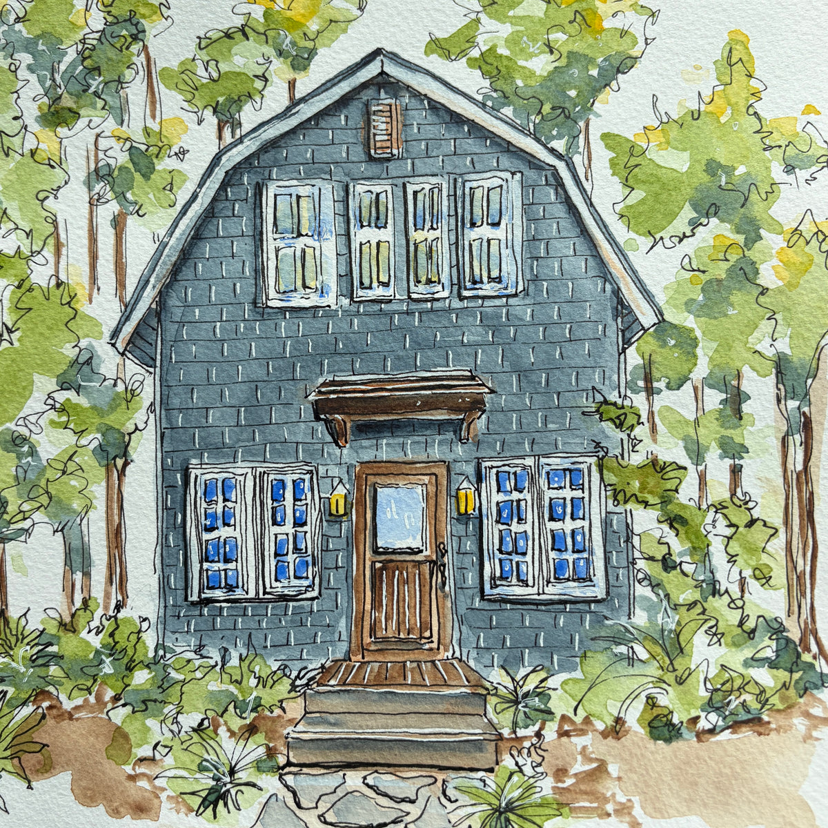 Watercolor and ink painting of a blue shingled gambrel cottage with a wooden front door, yellow lanterns and stone steps surrounded by trees