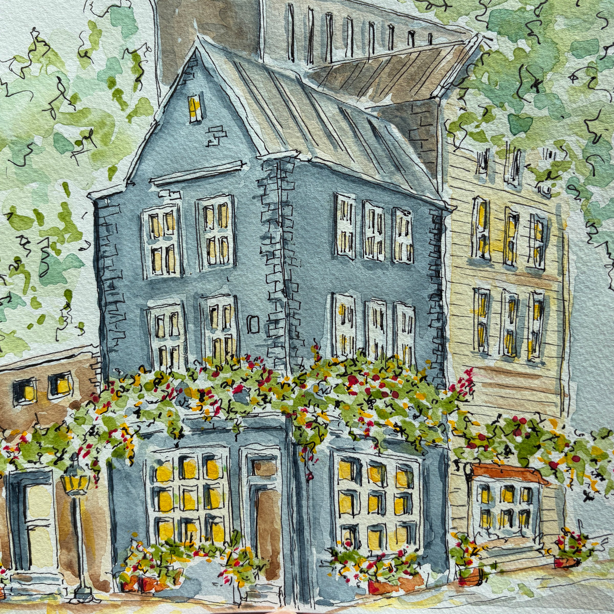 Full view of the blue stone townhouse watercolor with trees, flower boxes and a tin roof