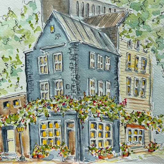 Full view of the blue stone townhouse watercolor with trees, flower boxes and a tin roof