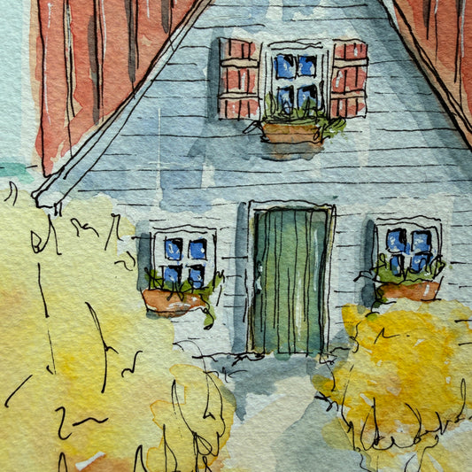Close-up of the seaside cottage watercolor showing the green door, red shutters and window boxes
