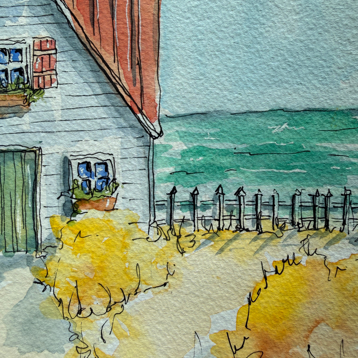 Detail of the seaside cottage watercolor showing the picket fence, turquoise waves and golden dune grass